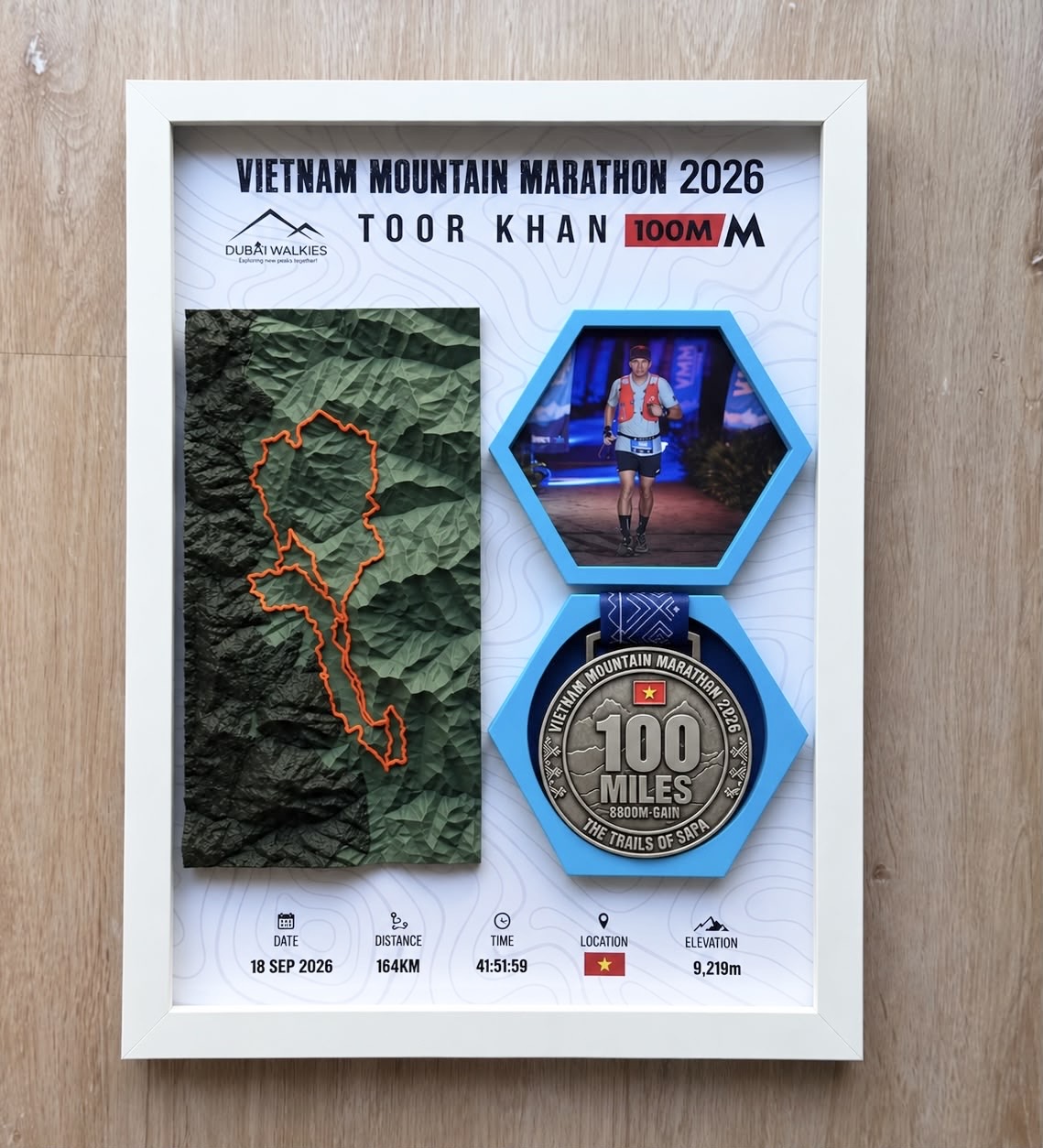 Vietnam Mountain Marathon 2026 — Toor Khan — Full white frame: 3D relief of the 100-mile Sapa loop, finisher photo and medal.