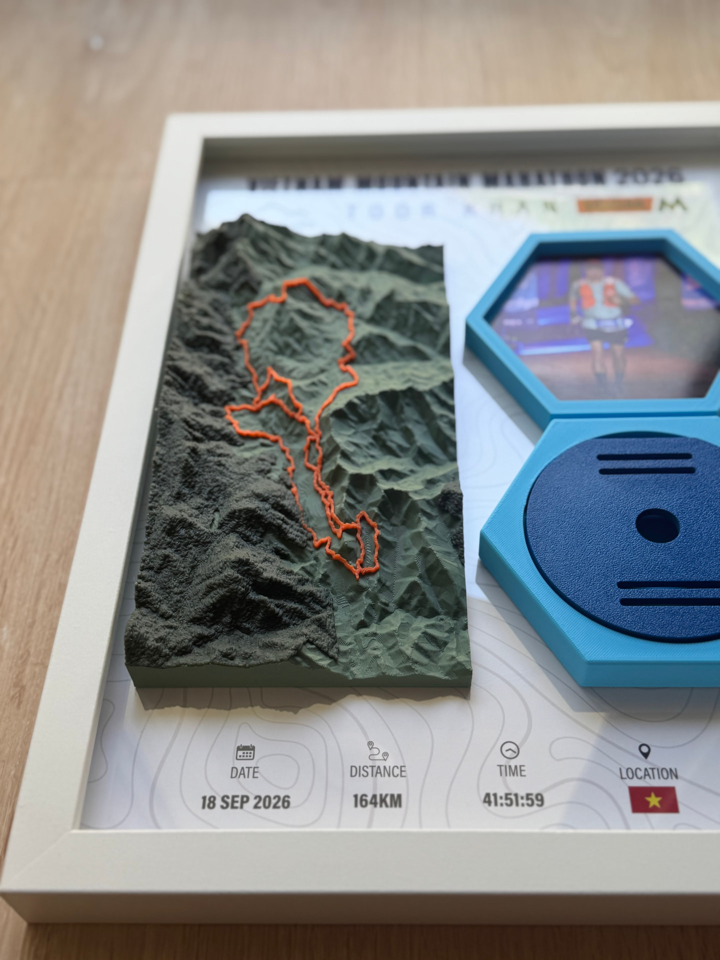 Vietnam Mountain Marathon 2026 — Frame Angle — Side view showing the depth of the printed terrain and the hex mounts.