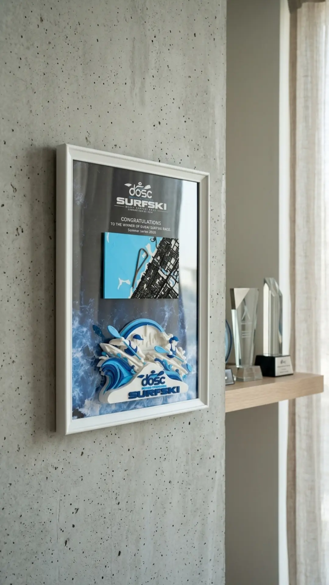 DOSC Surfski Dubai — Wall Display — The Surfski winner's frame mounted in a clubhouse beside the trophies.